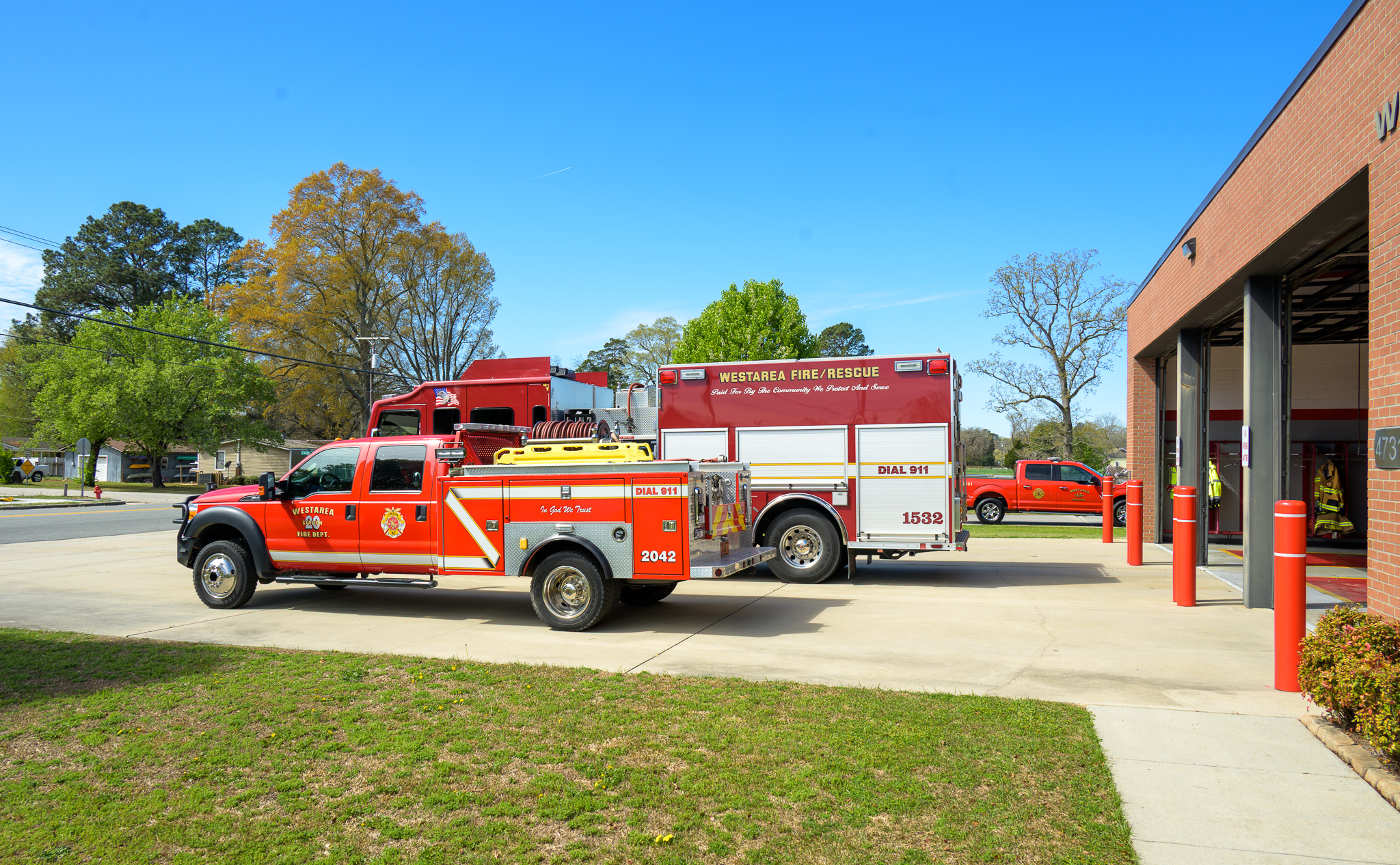 Rescue truck and engine at station driveway